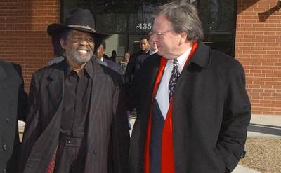 Brown walks out of jail beside his lawyers.