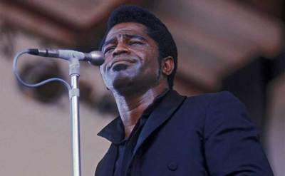 James Brown performs on stage.