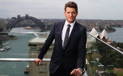Michael Buble poses on a balcony overlooking Sydney