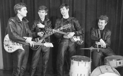The Beatles standing with Pete Best sitting behind his drums