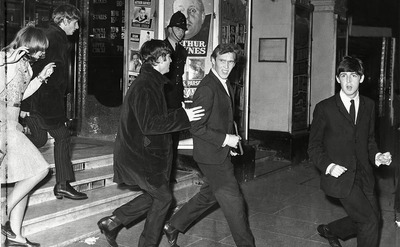 Ringo Starr, John Lennon, Paul McCartney, and Neil Aspinall running to their car in London