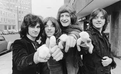 The members of Badfinger show off their bandaged fingers.