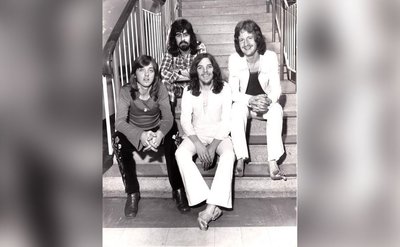 Badfinger poses for a photo backstage.