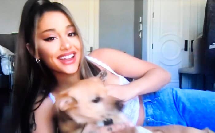 Ariana Grande appears on a television screen speaking during the MTV Video Music Awards.