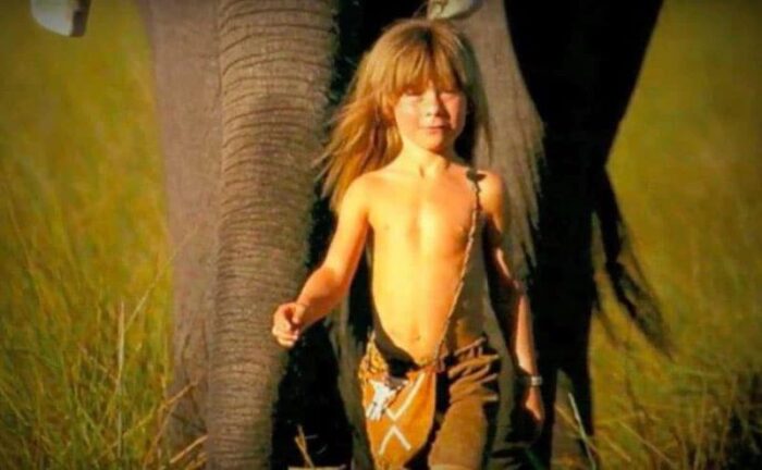 A photo of Tippi Degre playing with an elephant.