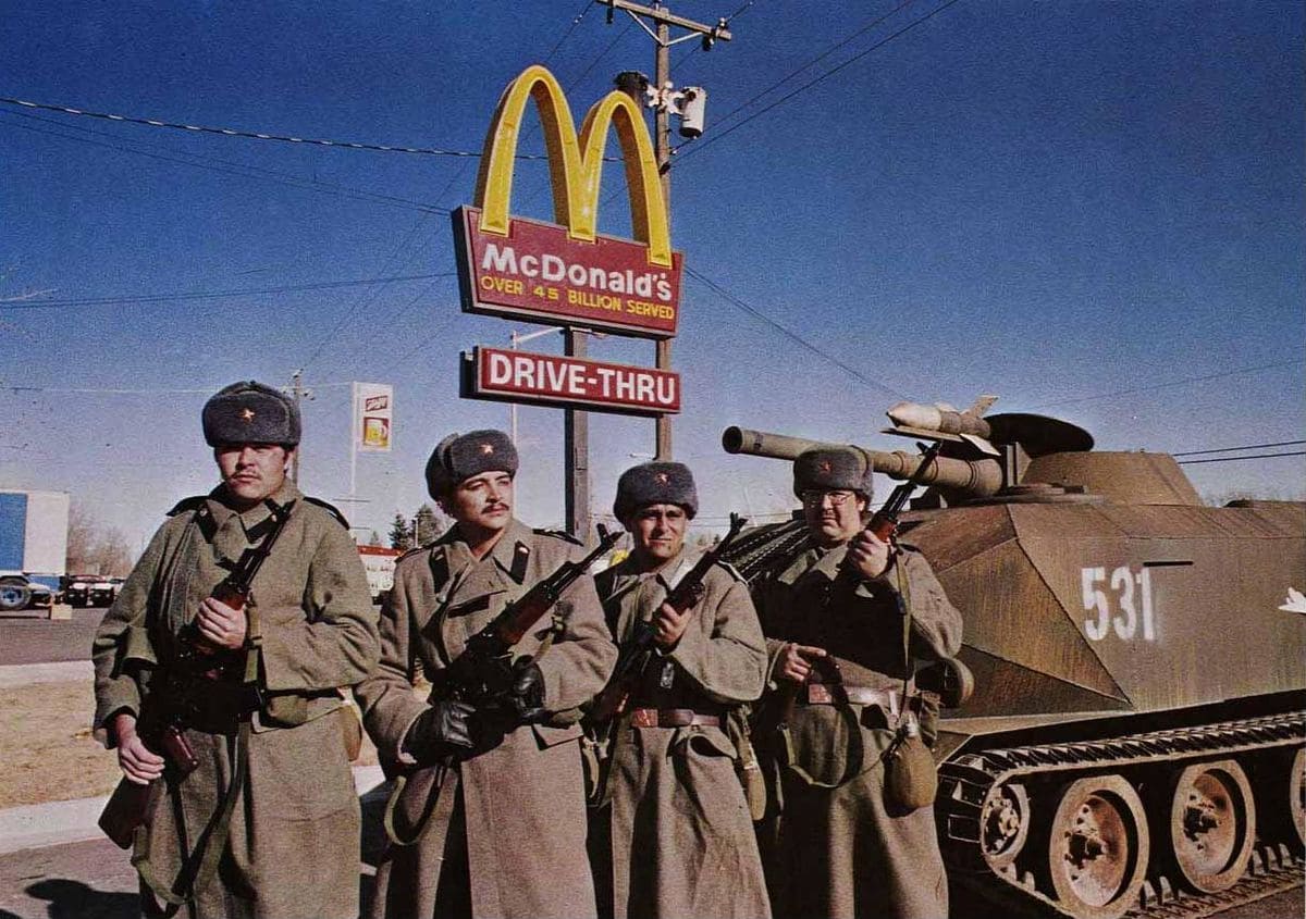  Soldiers and a Tank photographed in front of a McDonald's Drive-Thru.