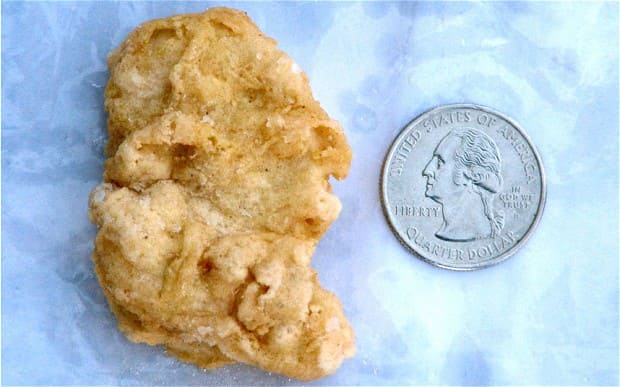 Photo of the George Washington McNugget next to a quarter with his profile.