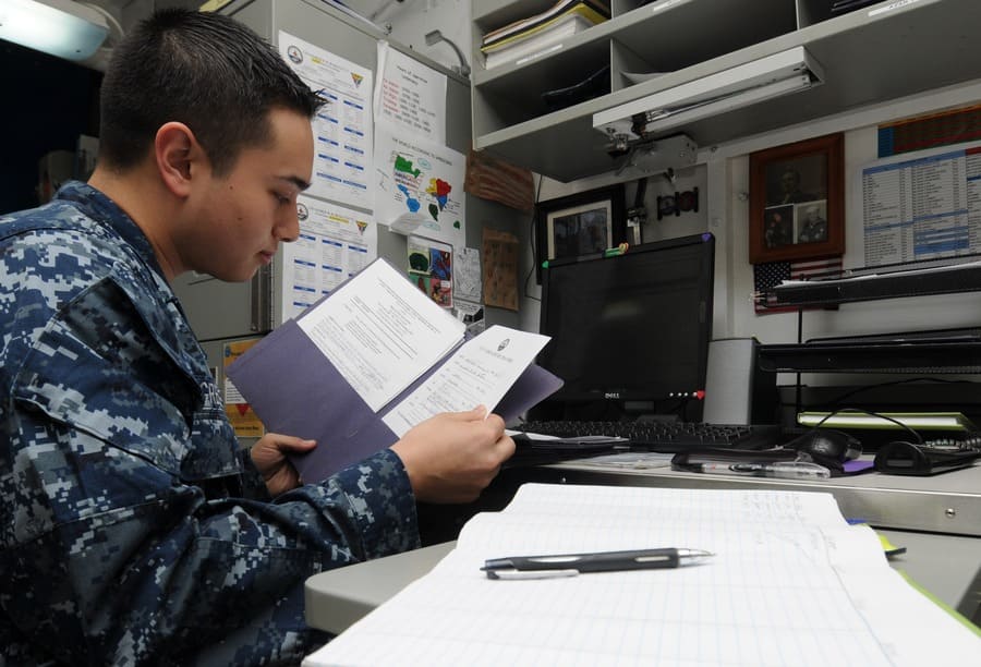 Reading over documents on an aircraft carrier
