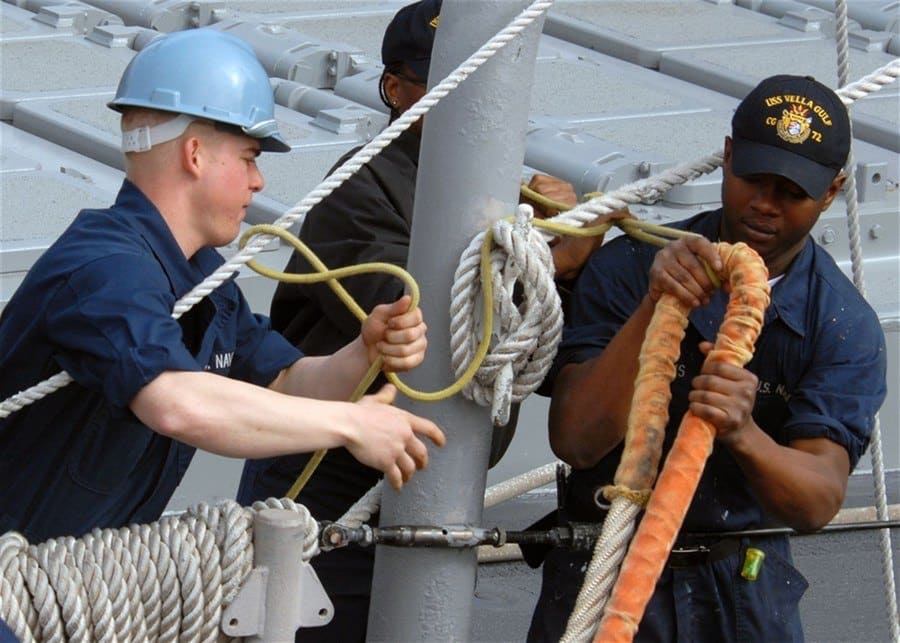 Tightening ropes on an aircraft carrier deck