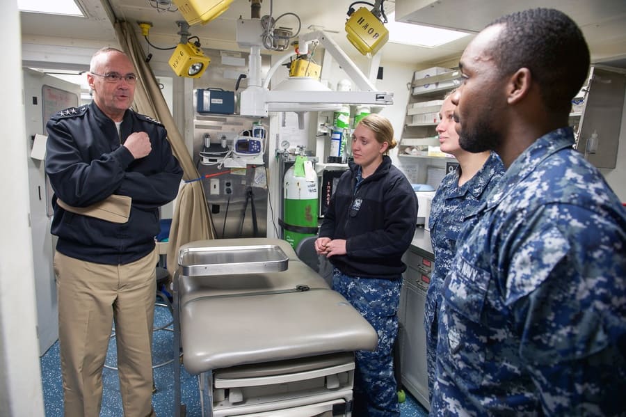 Standing in a medical care room on an aircraft carrier