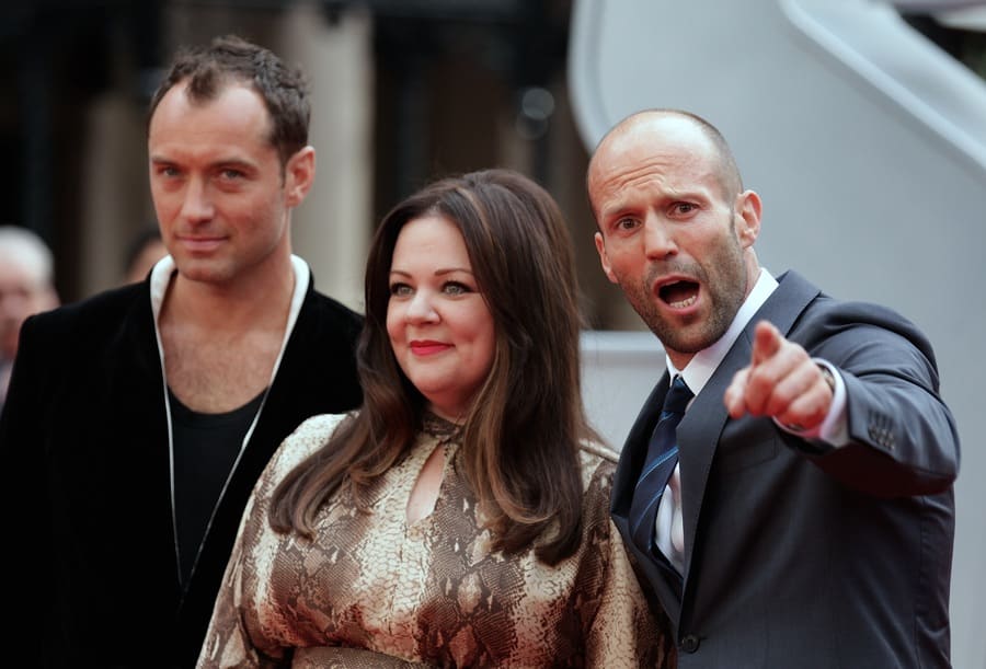 Jason Statham, pictured right, standing with Jude Law and Melissa McCarthy at a premiere in London.