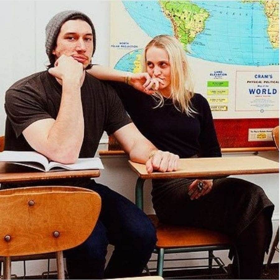 Joanne Tucker and Adam Driver are sitting at desks in a school.
