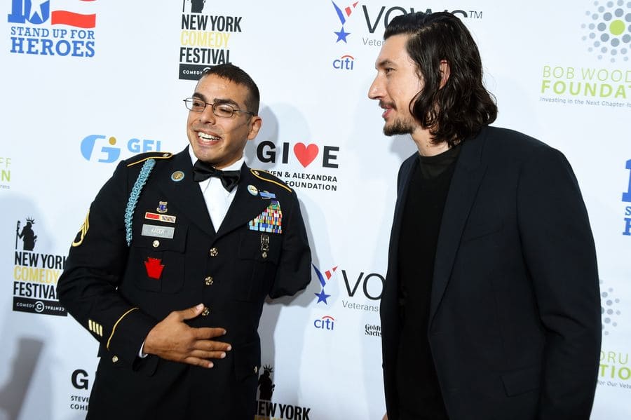 Adam and Michael Kacer, a soldier in his dress blues, posing for cameras at the Stand Up for Heroes event in New York.