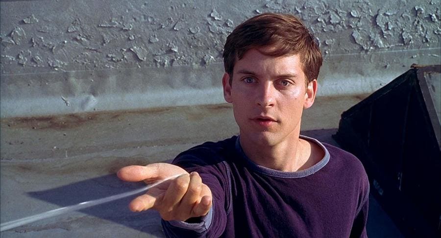 Tobey Maguire in character looking shocked with the spider web coming out of his wrist.