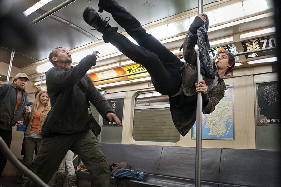Andrew Garfield is hanging onto a pole on the subway mid-fight in the Amazing Spider-Man. 