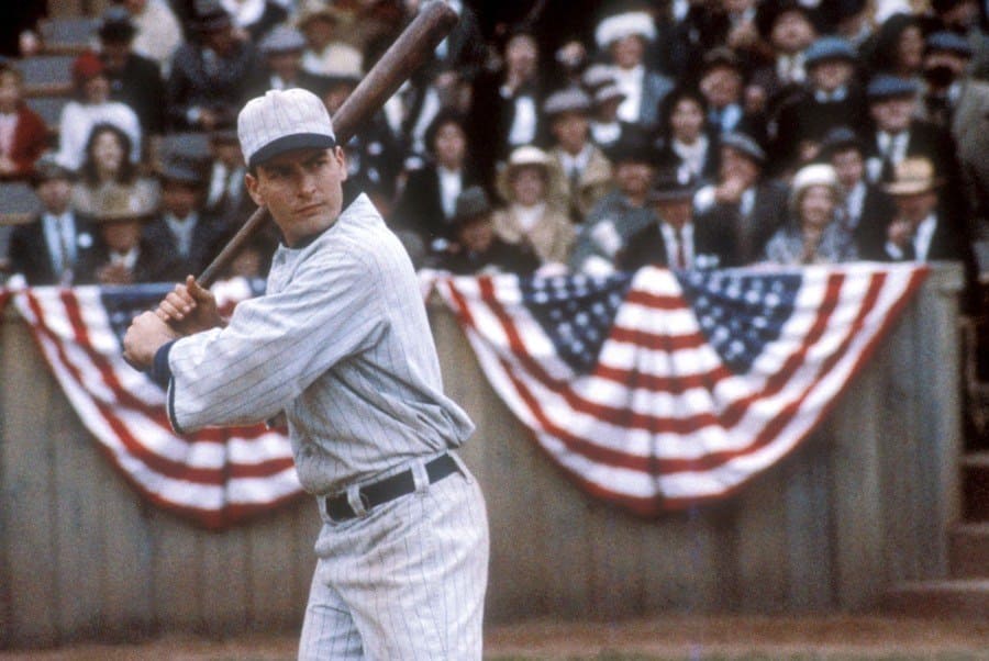 Charlie Sheen in the movie Eight Men Out, holding a baseball bat standing ready to hit. 