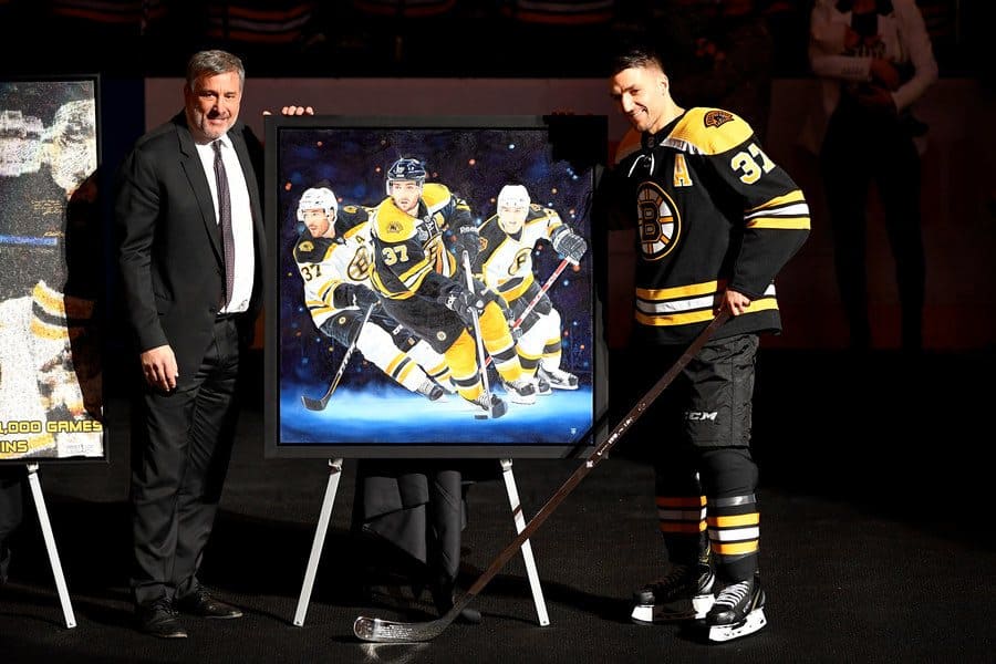Cam Neely presenting Patrice Bergeron with a painting for his 1000th game. 