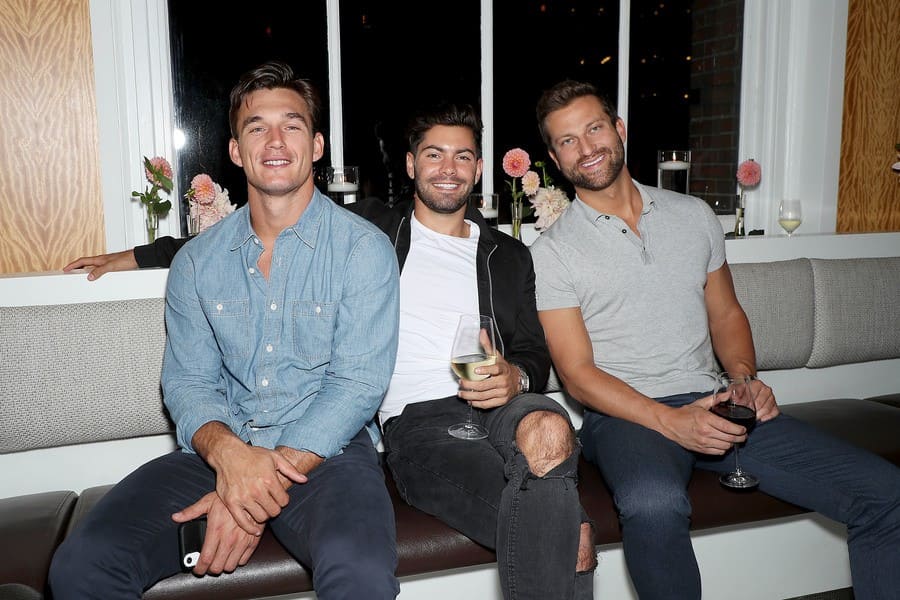 Tyler, Dylan, and Chris B. were sitting on the couch at a celebratory dinner. 