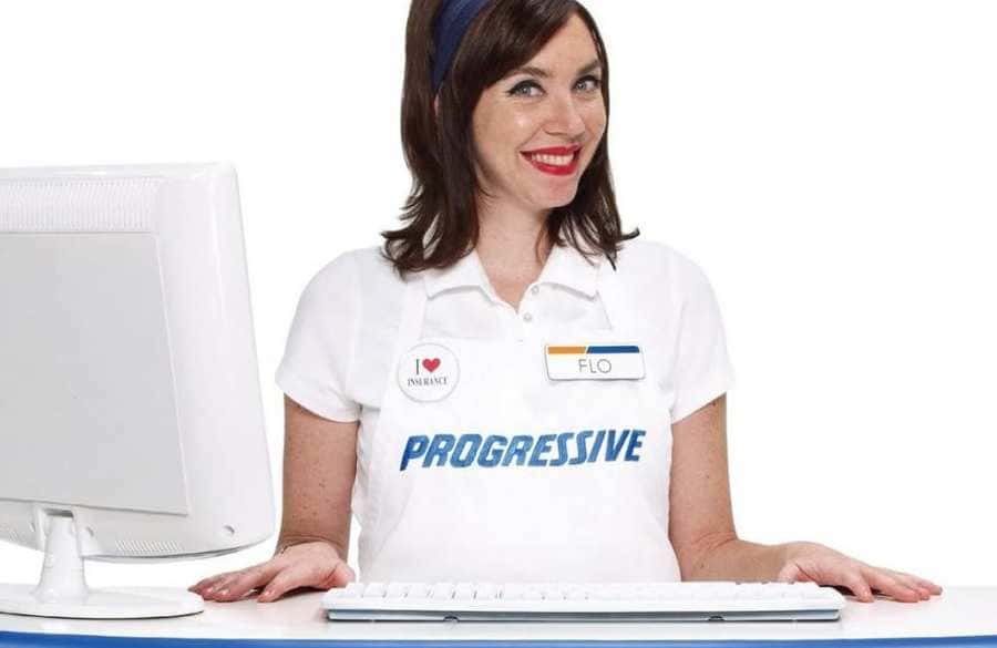 Stephanie Courtney in a white polo shirt with Progressive written across it and a name tag.