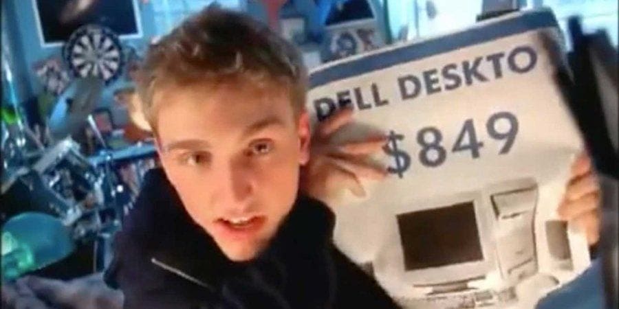Ben Curtis holding up an ad for a Dell Desktop in the commercial.