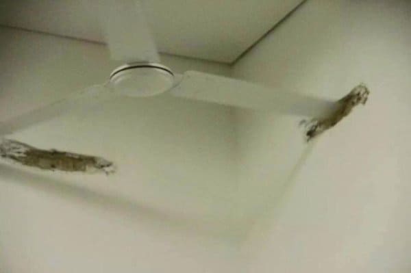 A fan from the ceiling making holes in the walls