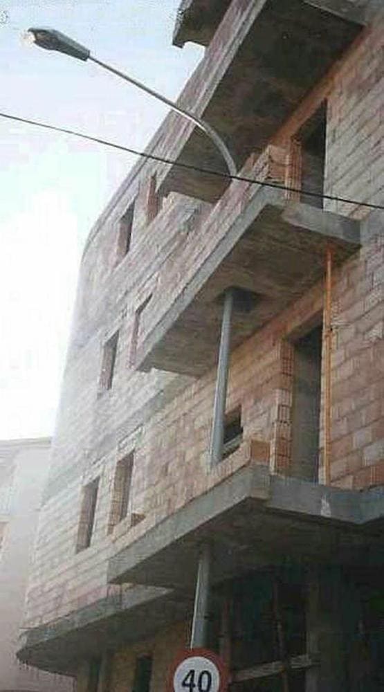 A lamp post going through balconies