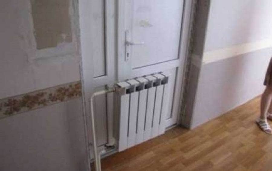 Radiator Installed In Front Of Door