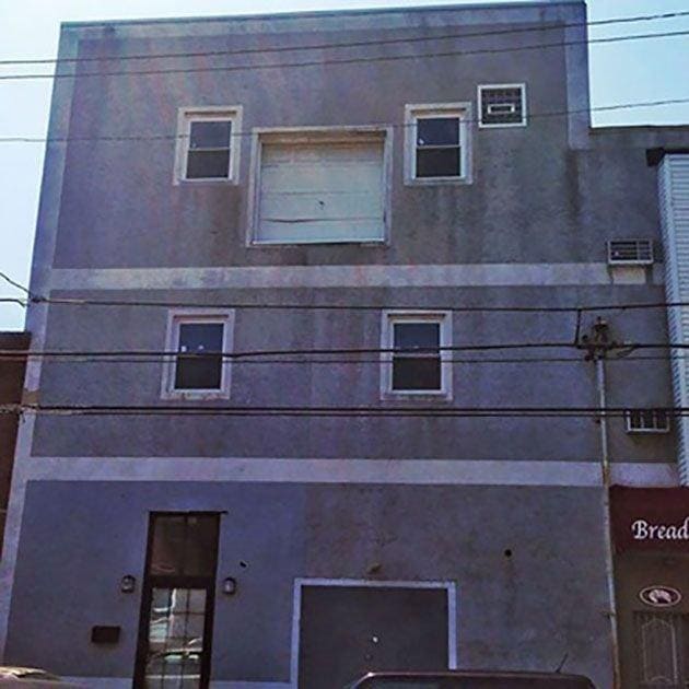 A garage door on the second floor of a building