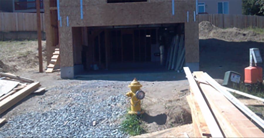 A fire hydrant in front of a garage entrance