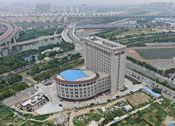 a birds-eye view of abuilding looking like a gigantic toilet