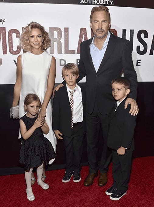 Christine Baumgartner and Kevin Costner posing with their children when they were younger