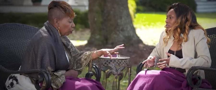 Screenshot of Iyanla Vanzant and Marie Holmes having a conversation sitting on lawn furniture during an episode of 'Iyanla: Fix My Life.' 