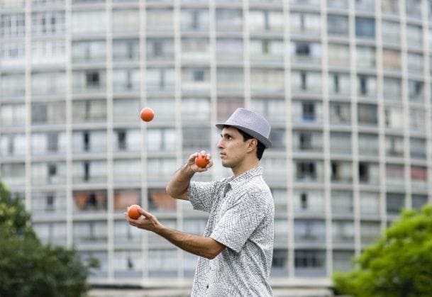 man juggling outside