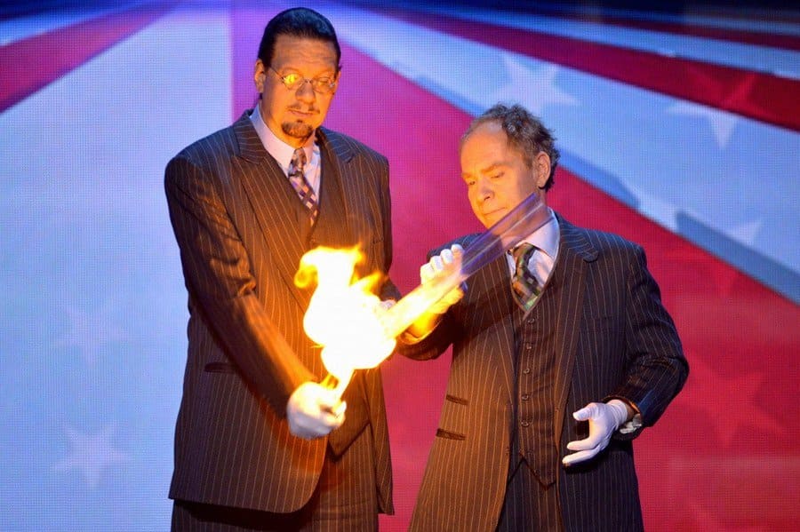 Penn and Teller on stage with fire