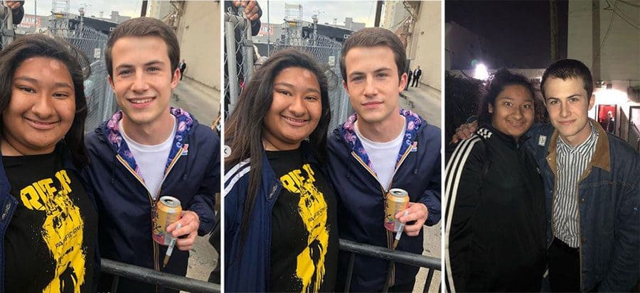 Marlen and Dylan are holding a can of soda and a gold sharpie posing in front of a gate. / The two are posing in front of the gate again. / Dylan is in a denim jacket, and Marlen is in an Adidas jacket posing in front of a back door to a building.