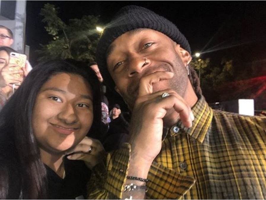 Ty Dollar $ign and Marlen are posing together outside of an event.