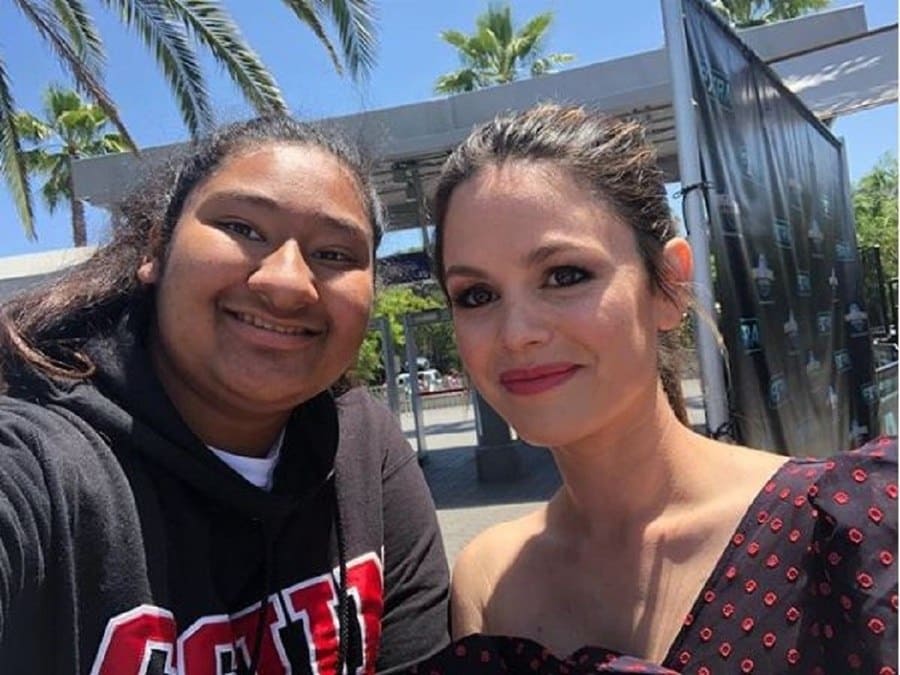 Rachel Bilson and Marlen Orozco are posing together for a selfie at an event with the screen just off in the background.