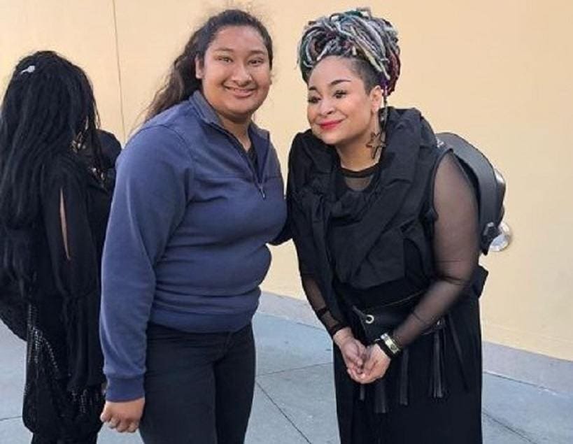 Raven Symone and Marlen Orozco are posing together outside of an event.