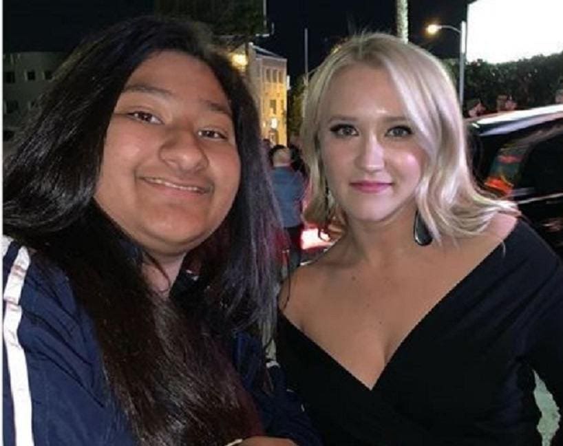 Marlen Orozco is posing with Emily Osment, who is wearing a black V-neck dress