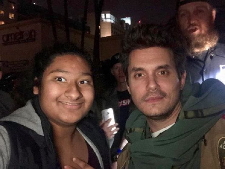 John Mayer and Marlen are posing for the camera.