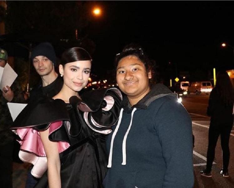 Sofia and Marlen are posing for a photograph together.