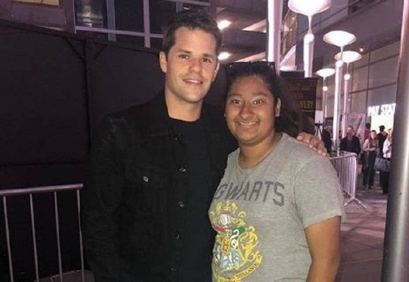 Max Carver and Marlen Orozco are posing together outside of an event.