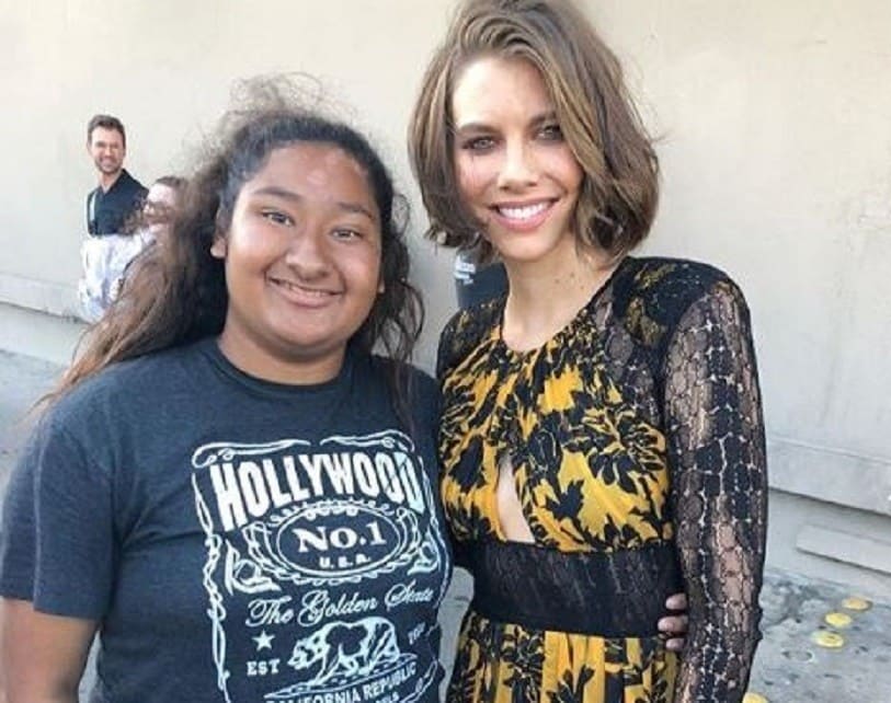 Lauren Cohen is in a beautiful floral yellow and black dress, together with Marlen are posing outside of an event.