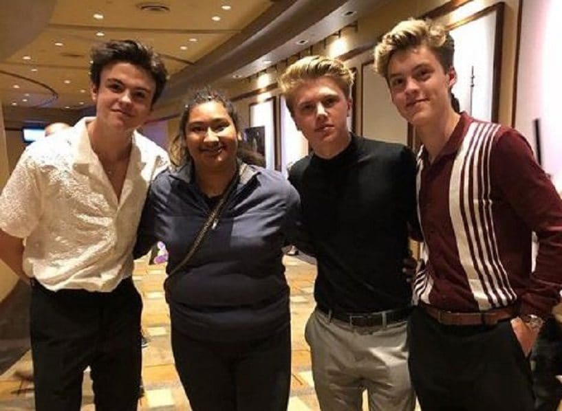 Reece Bibby, Blake Richardson, and George Smith are posing with Marlen Orozco at the Radio Disney Music Awards.