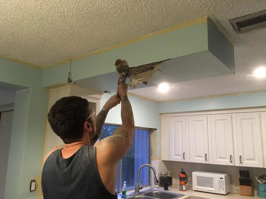 Bobby Kapsidis breaking the kitchen ceiling