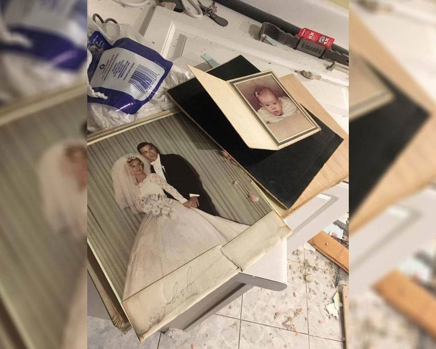 Family photos in a mess on the kitchen floor