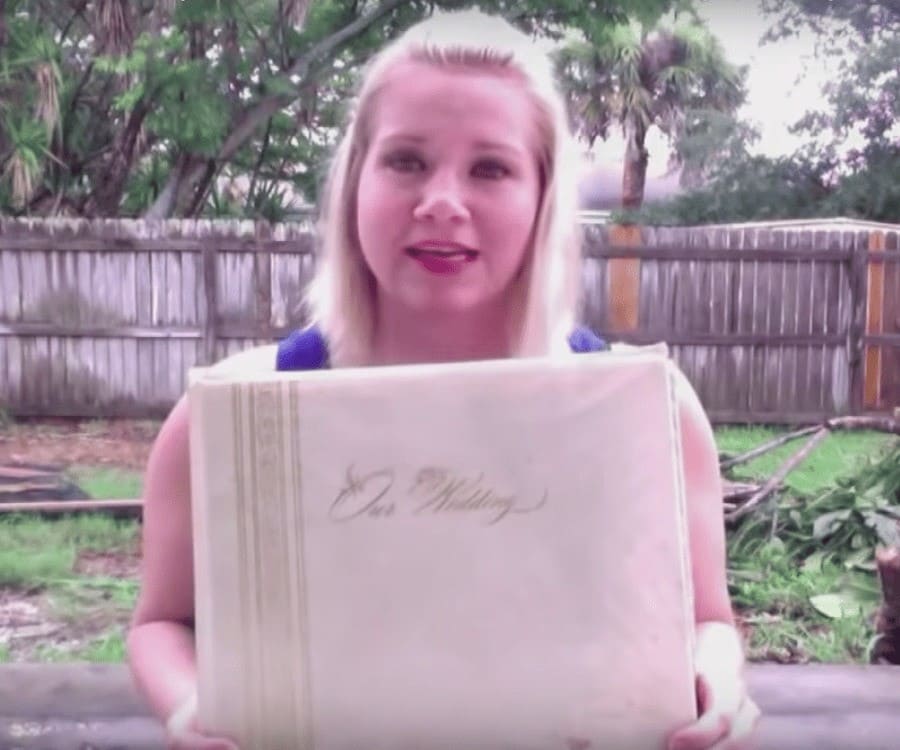 Megan holding up the wedding album