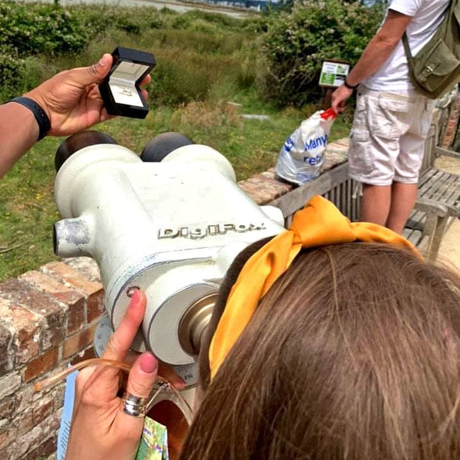 Cally looking through long-distance binoculars with the ring right up next to it so she couldn’t see it.