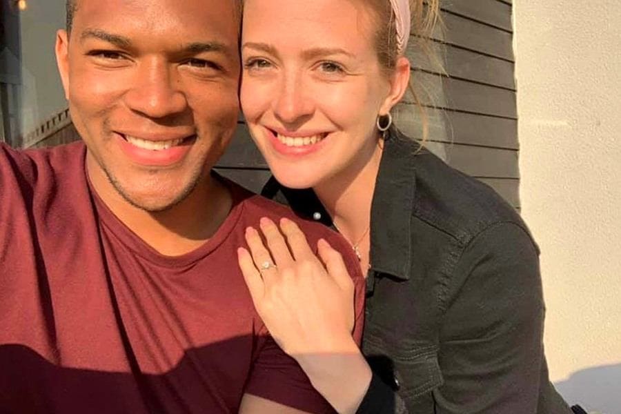 Cally and Edi posing together with Cally’s hand on his shoulder, showing off the engagement ring.