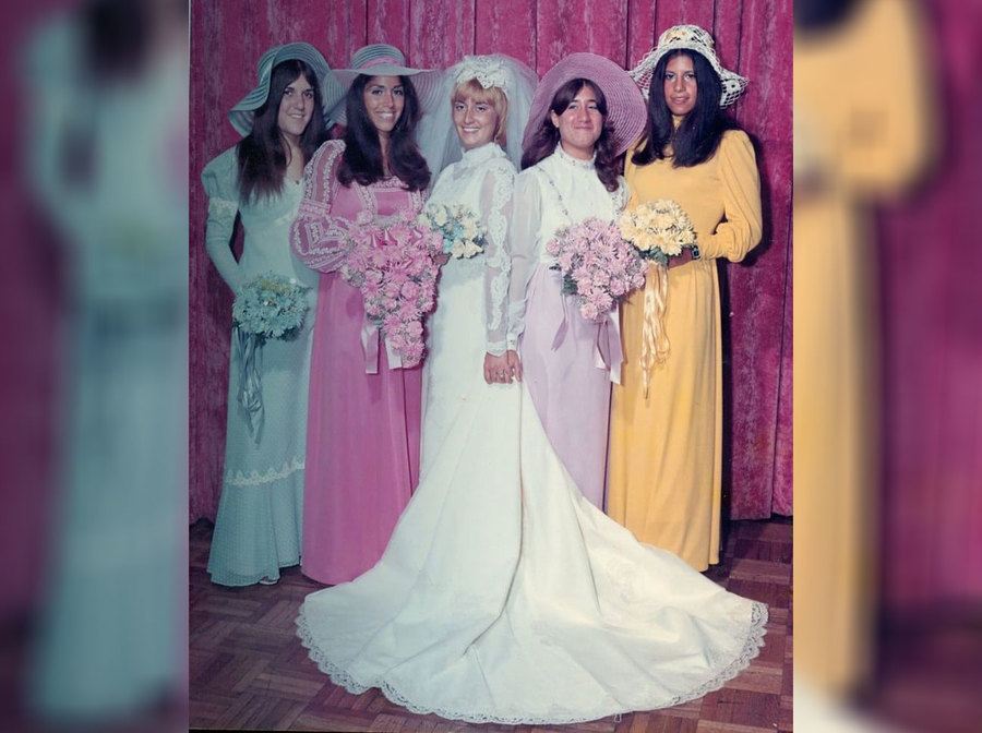 A bride and her bridesmaids wearing hats